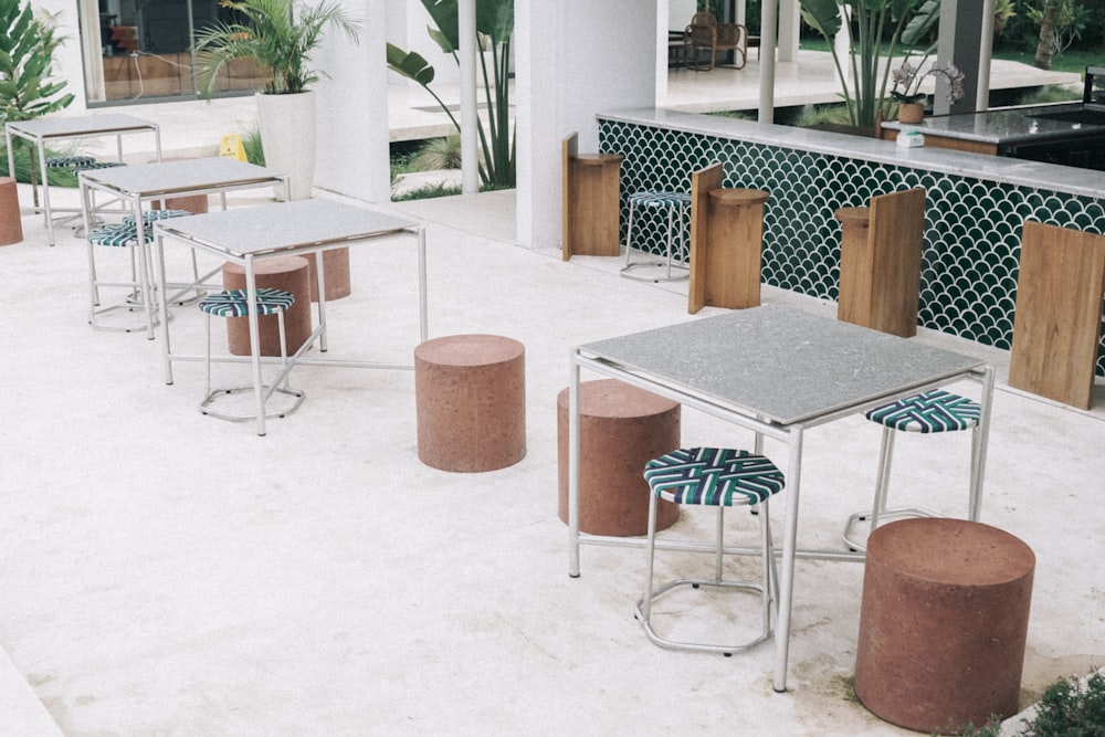 a group of tables and stools on a patio