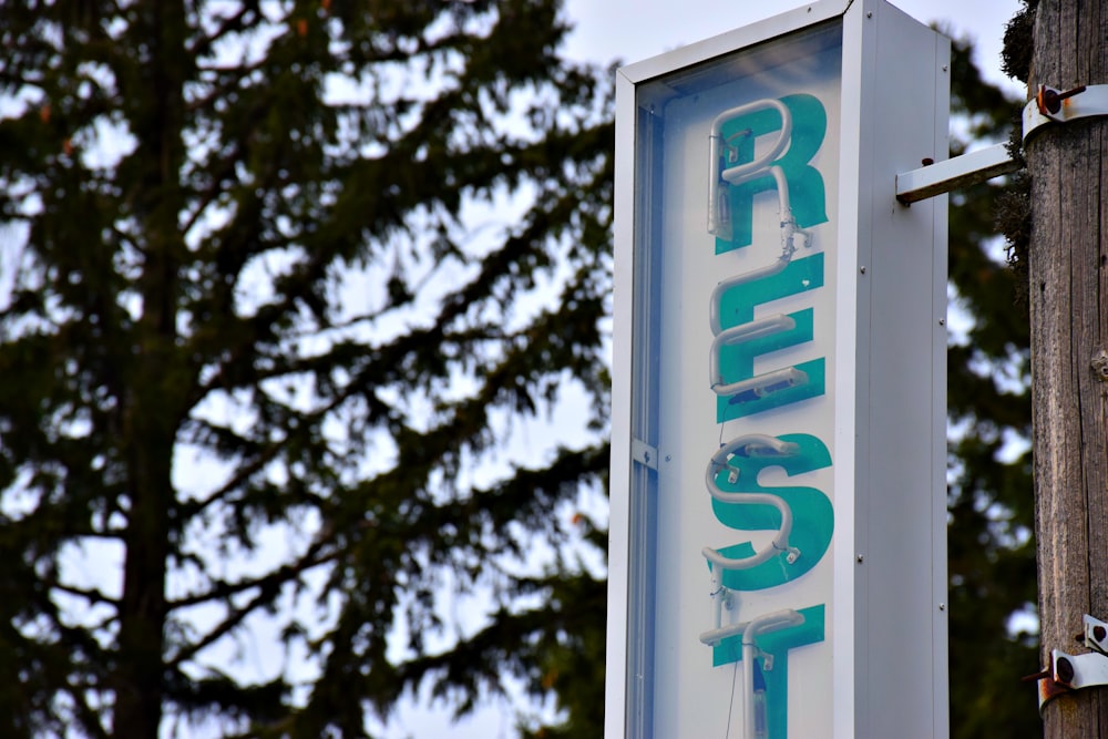 a sign on a telephone pole with trees in the background