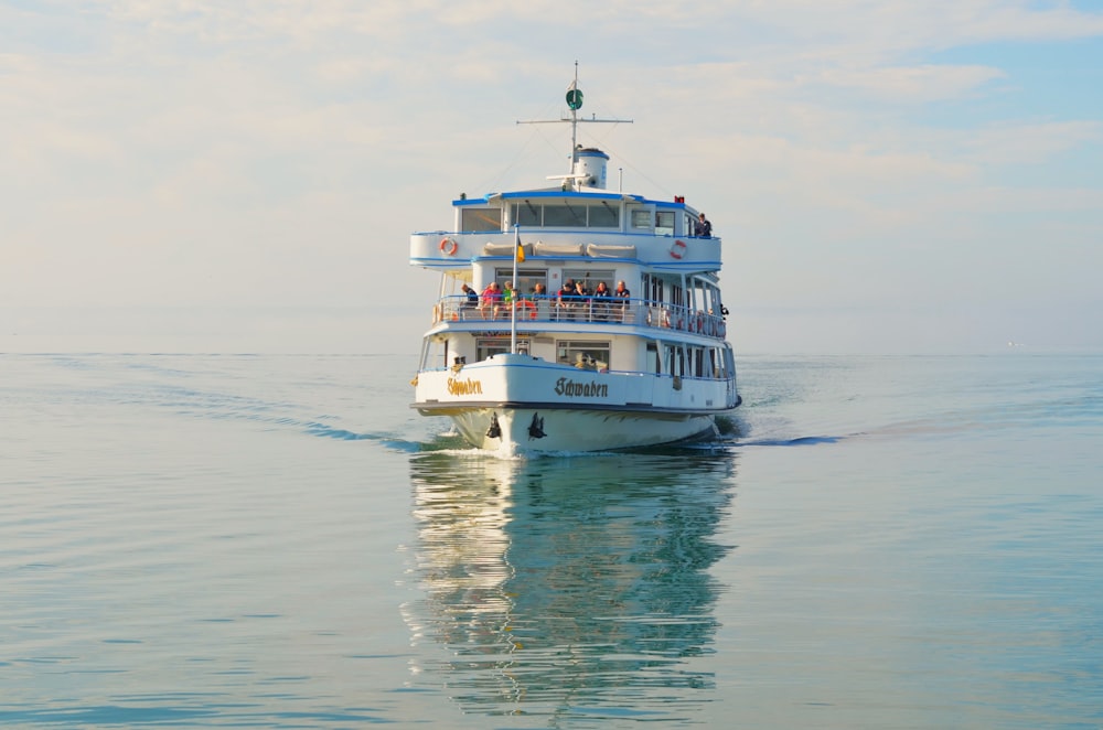 a large white boat floating on top of a large body of water