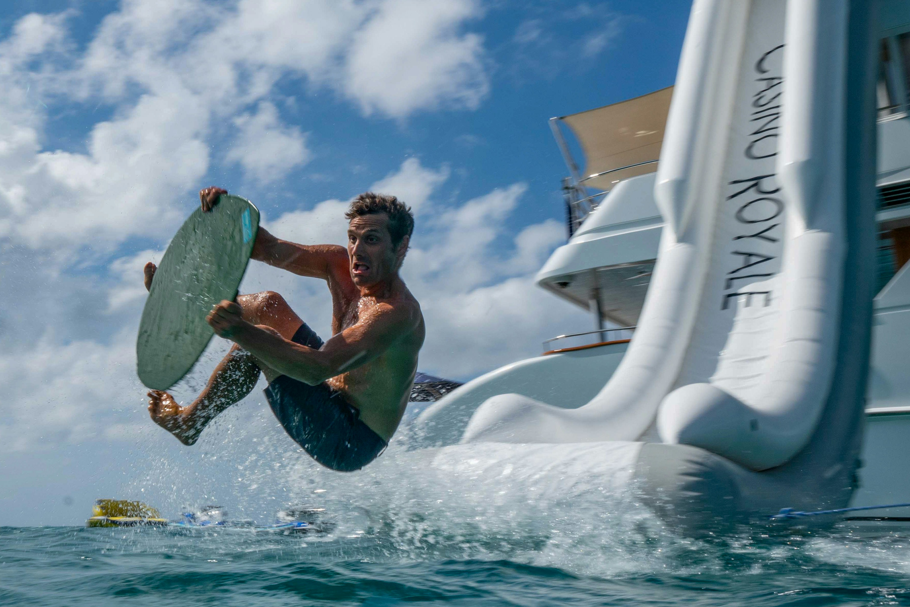 a man jumping in the air while holding a surfboard