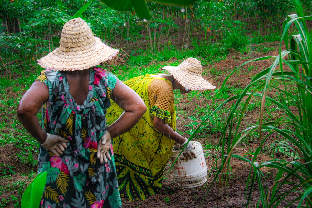 a couple of women standing next to each other in a field