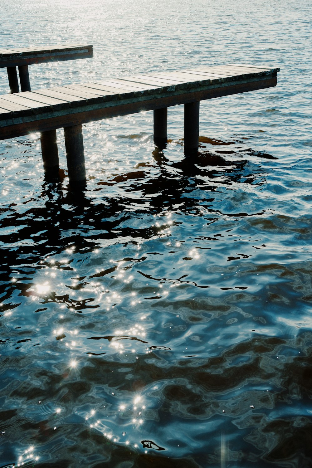 a wooden dock in the middle of a body of water