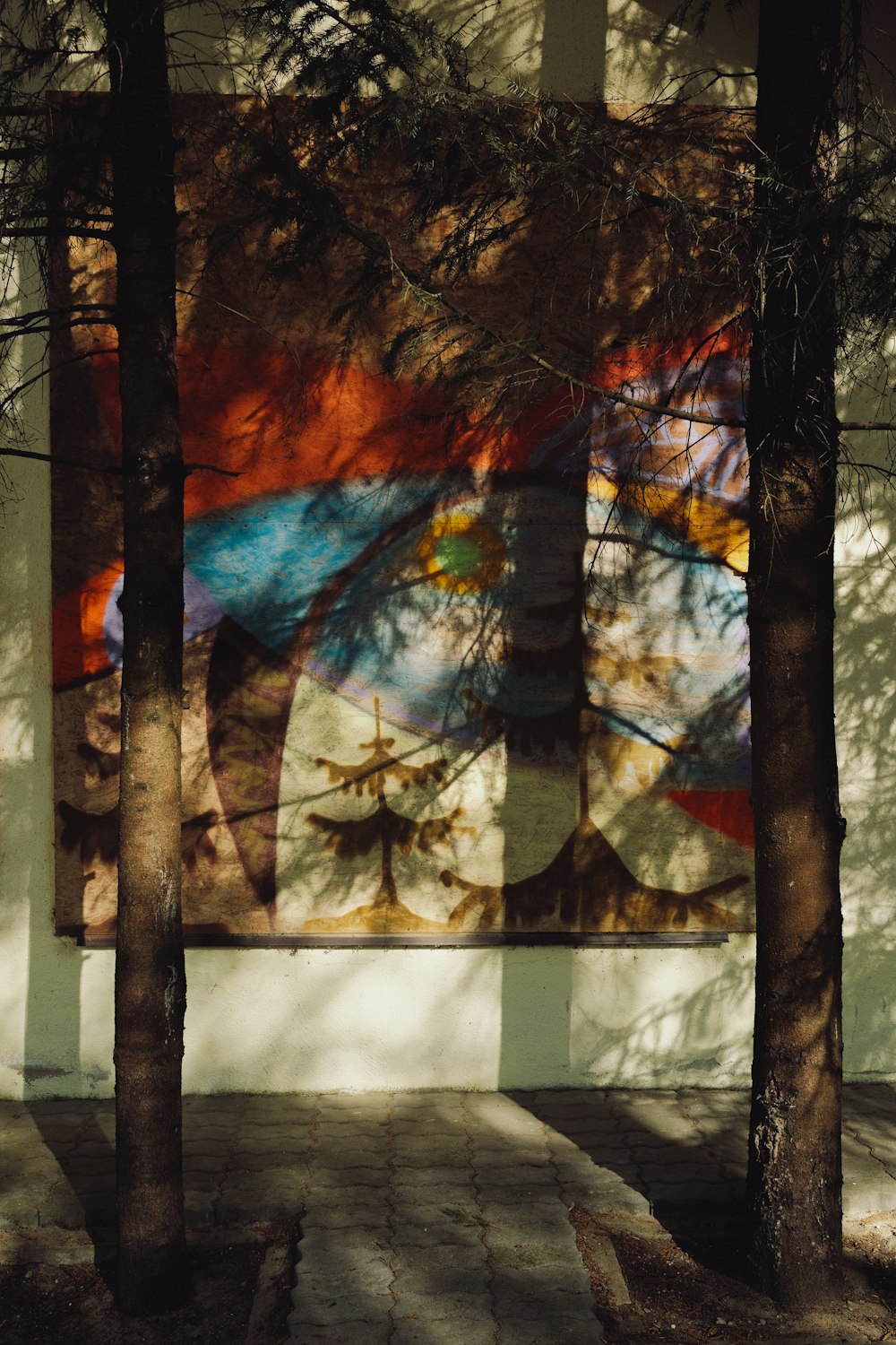 a picture of trees and a painting on a wall