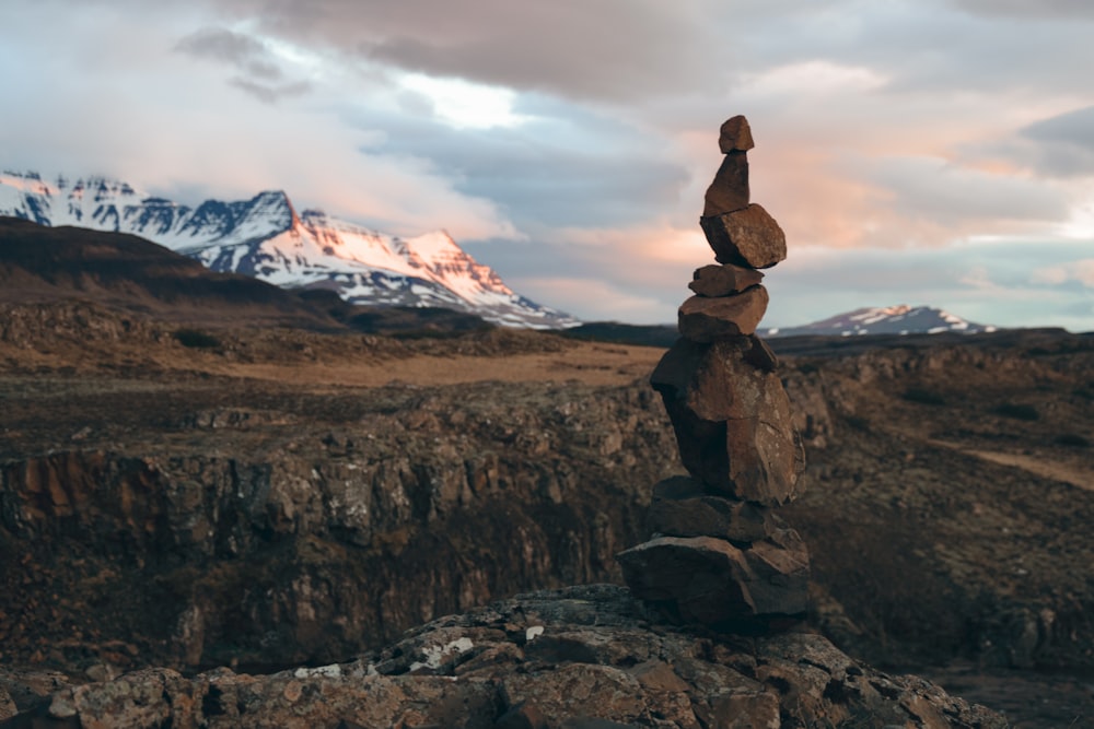 a stack of rocks sitting on top of a rocky hillside