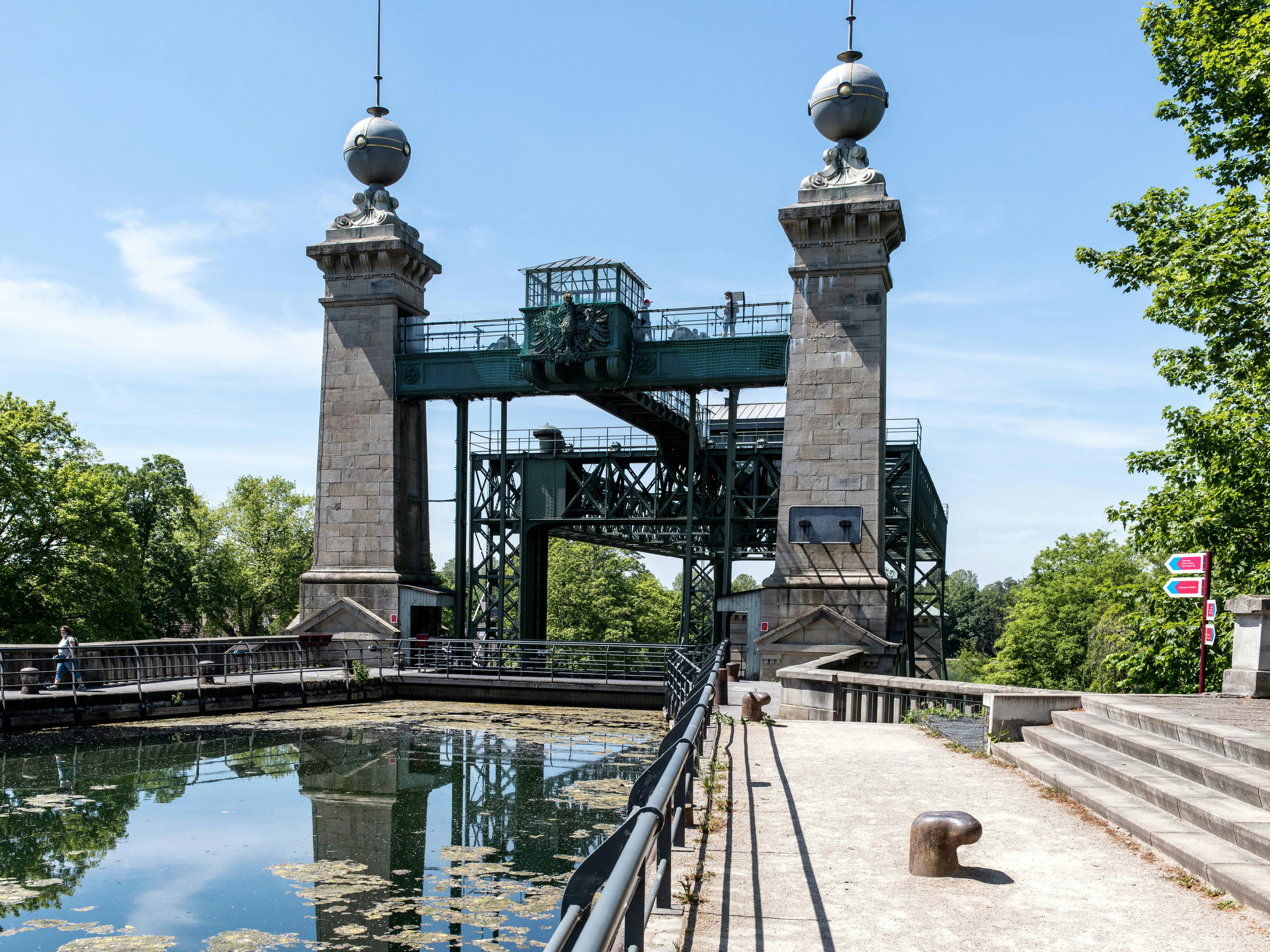 a bridge over a body of water with statues on top of it