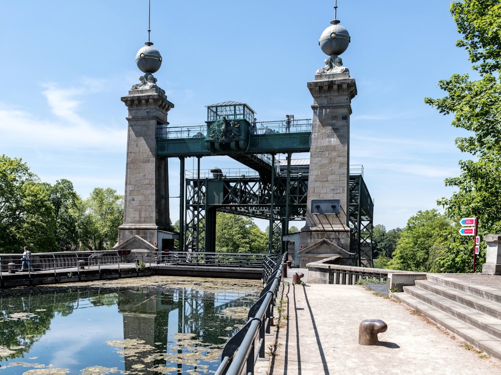 a bridge over a body of water with statues on top of it