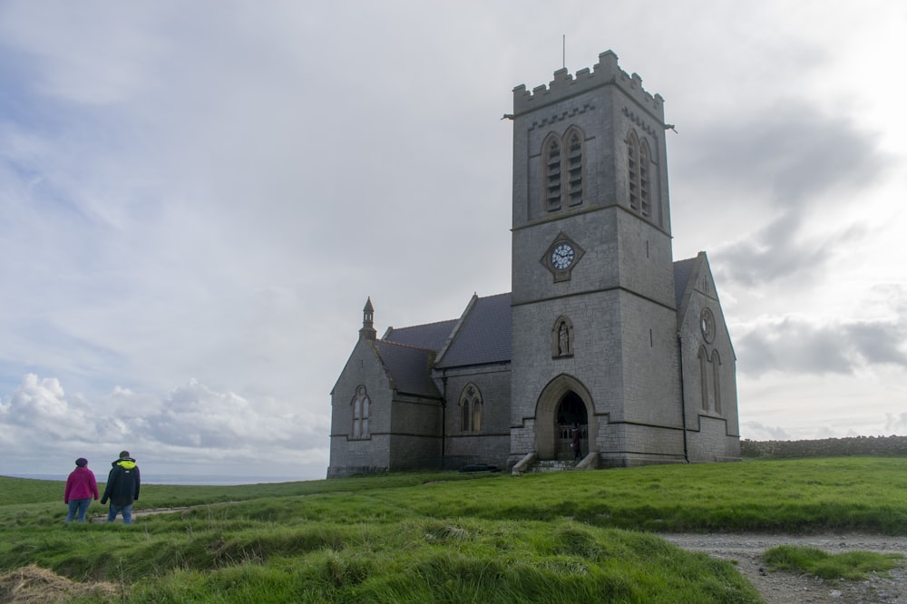 a couple of people standing in front of a church