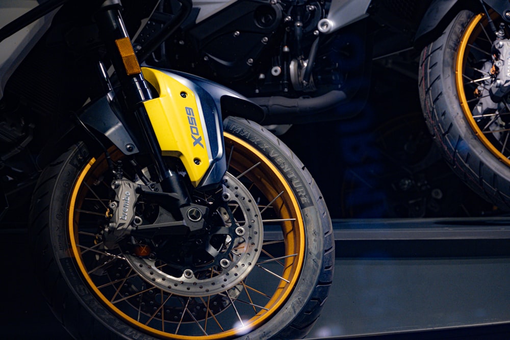 a yellow and black motorcycle parked in a garage
