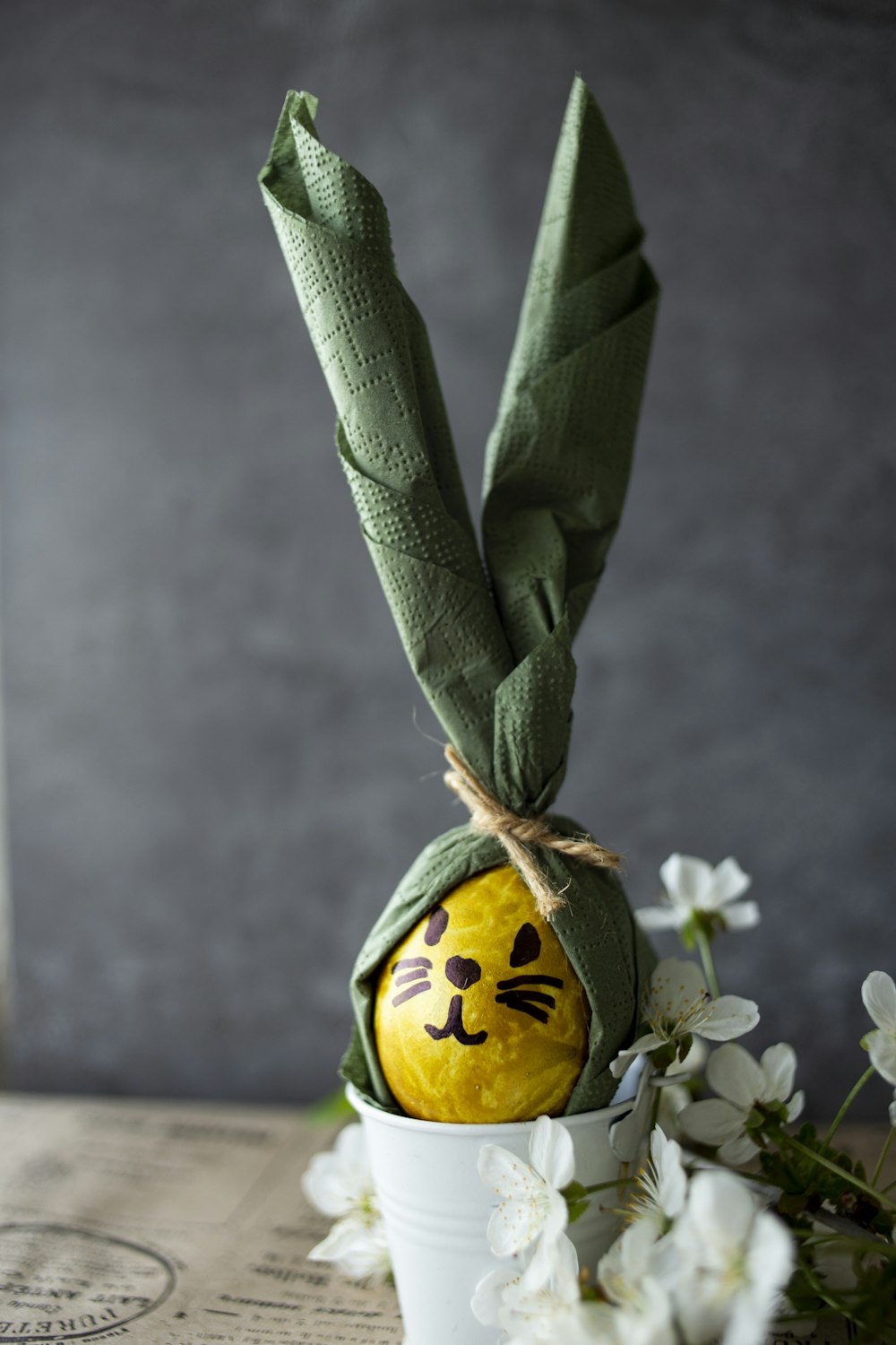 an easter egg decorated like a cat in a flower pot