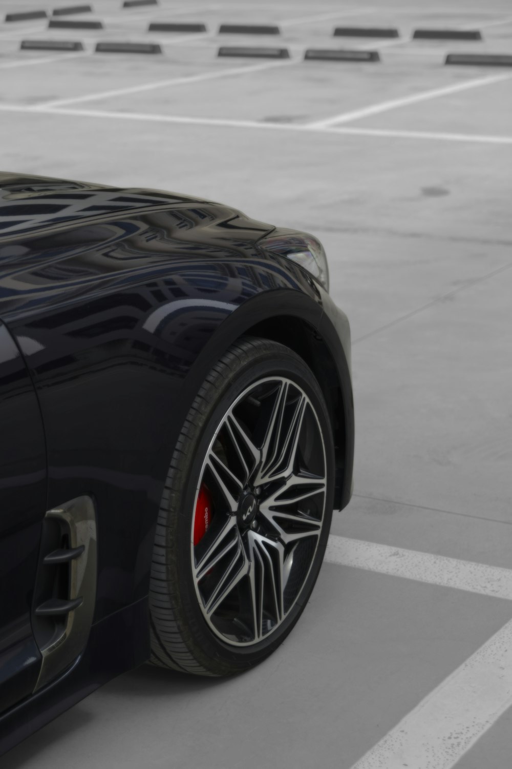 a black sports car parked in a parking lot