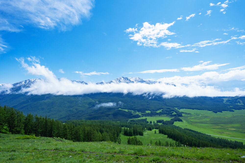 a view of a mountain range with clouds in the sky