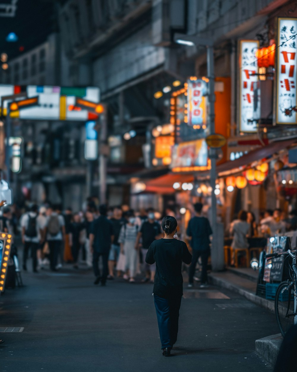 a man walking down a street at night