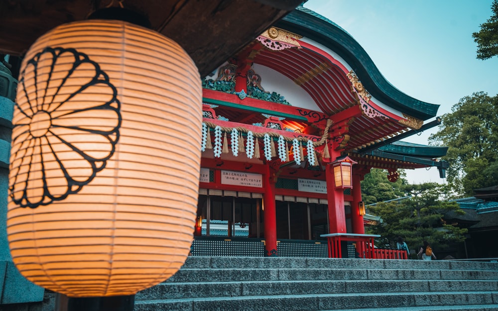 a red building with a large lantern hanging from it's side