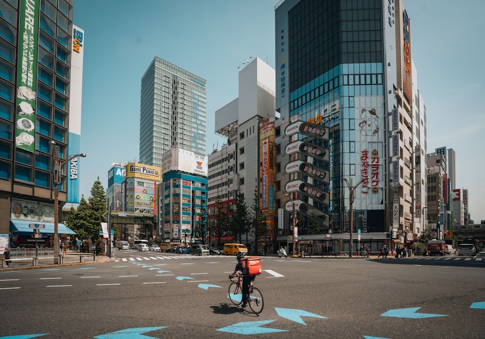 a person riding a bike on a city street