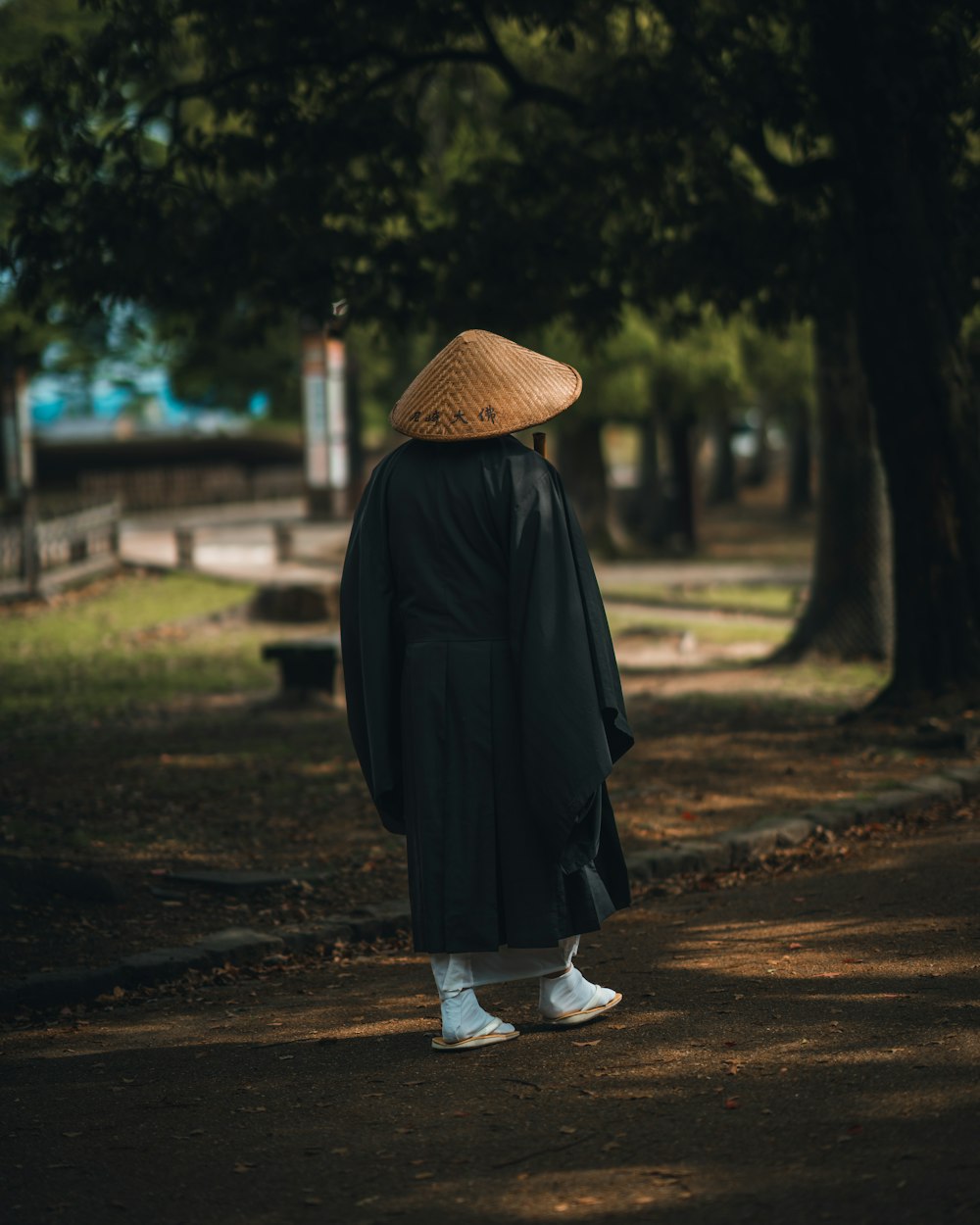 a person wearing a hat and a black coat