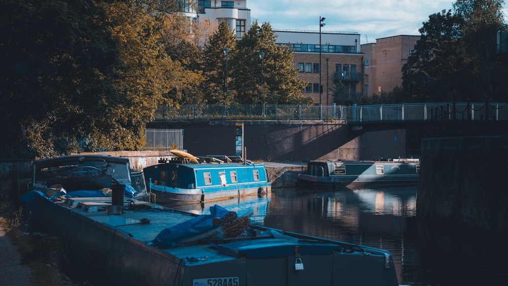 a boat is docked in the water near a bridge