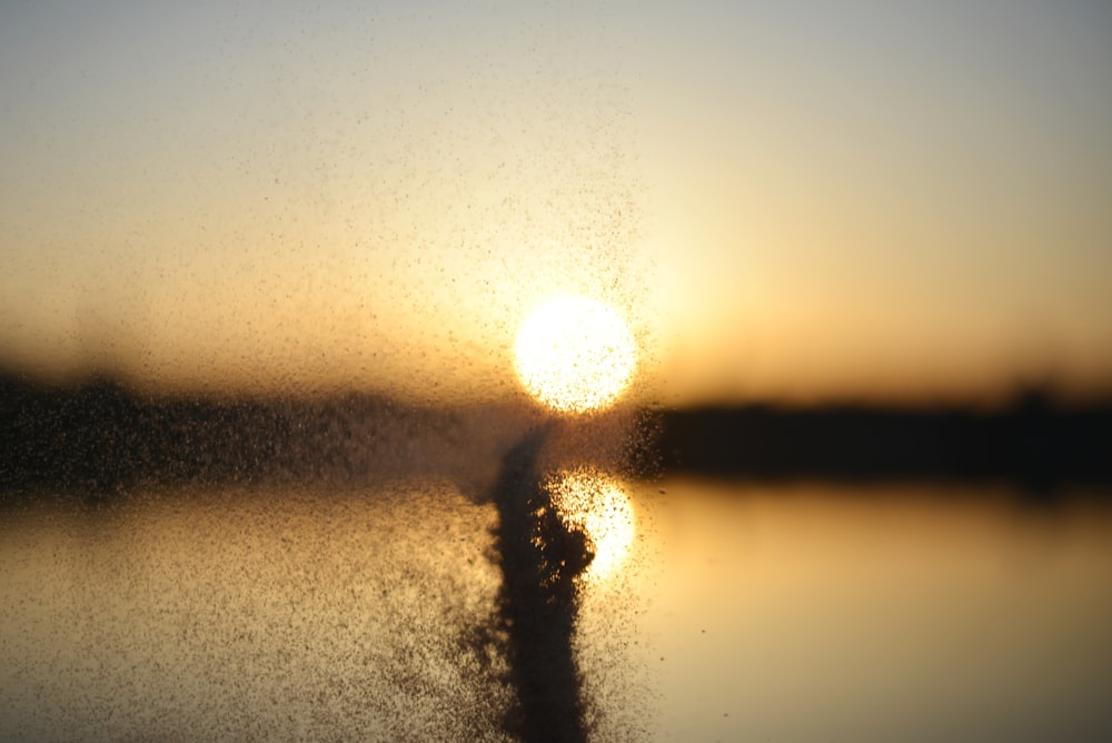 the sun is setting over a body of water