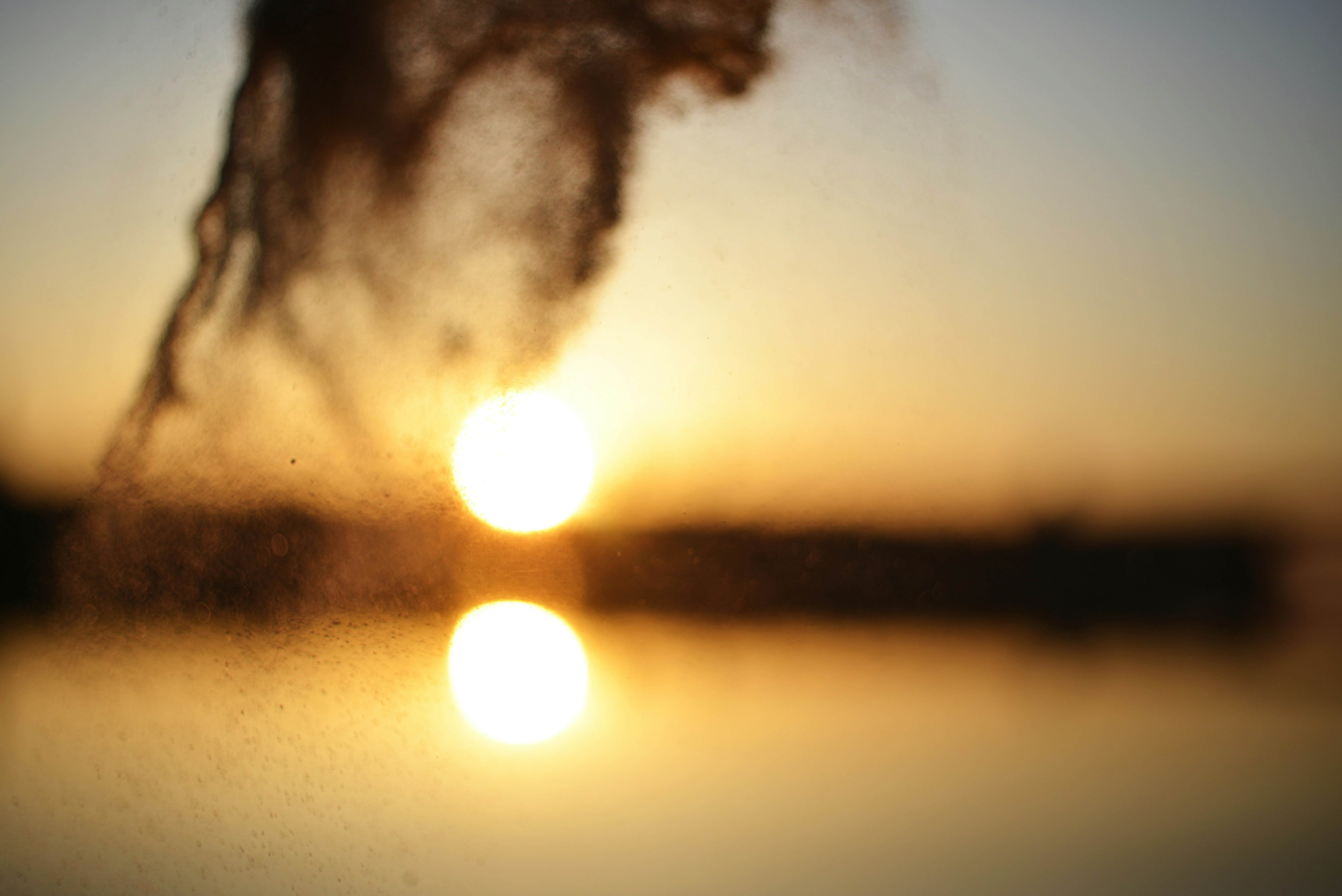 the sun is setting over a body of water