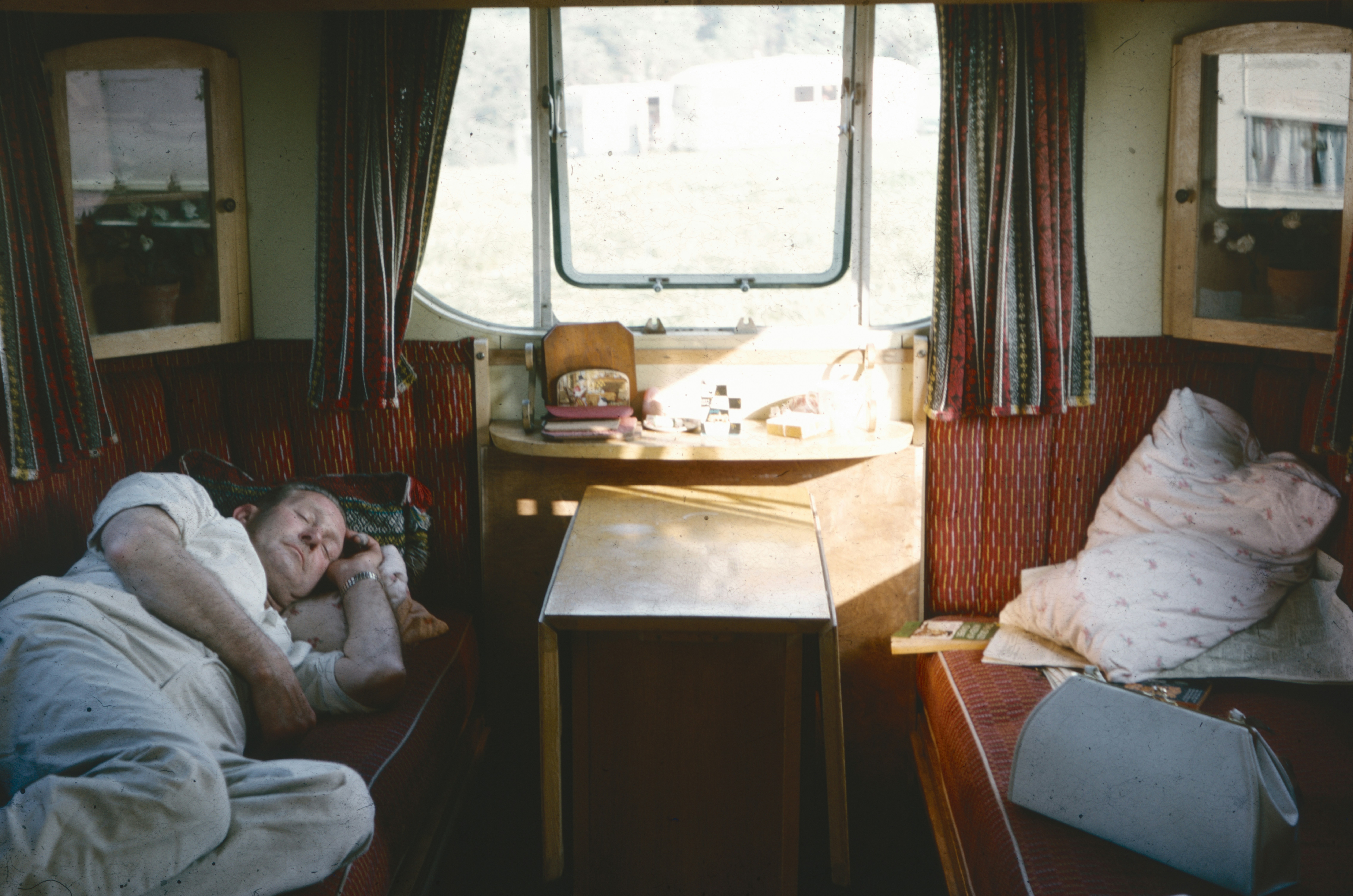 a couple of beds sitting inside of a train car, 