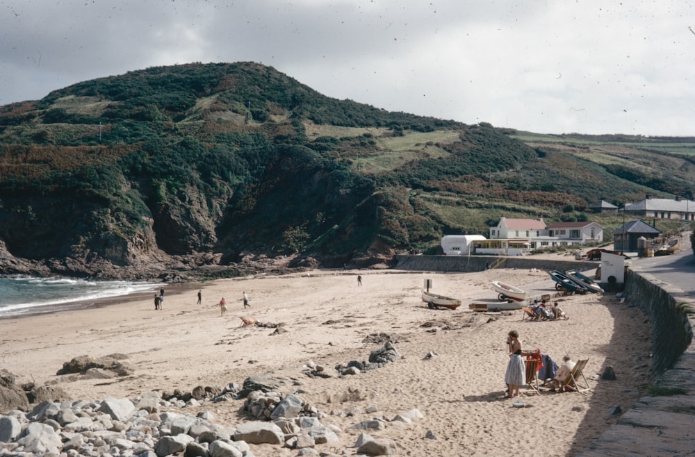 a group of people standing on top of a sandy beach