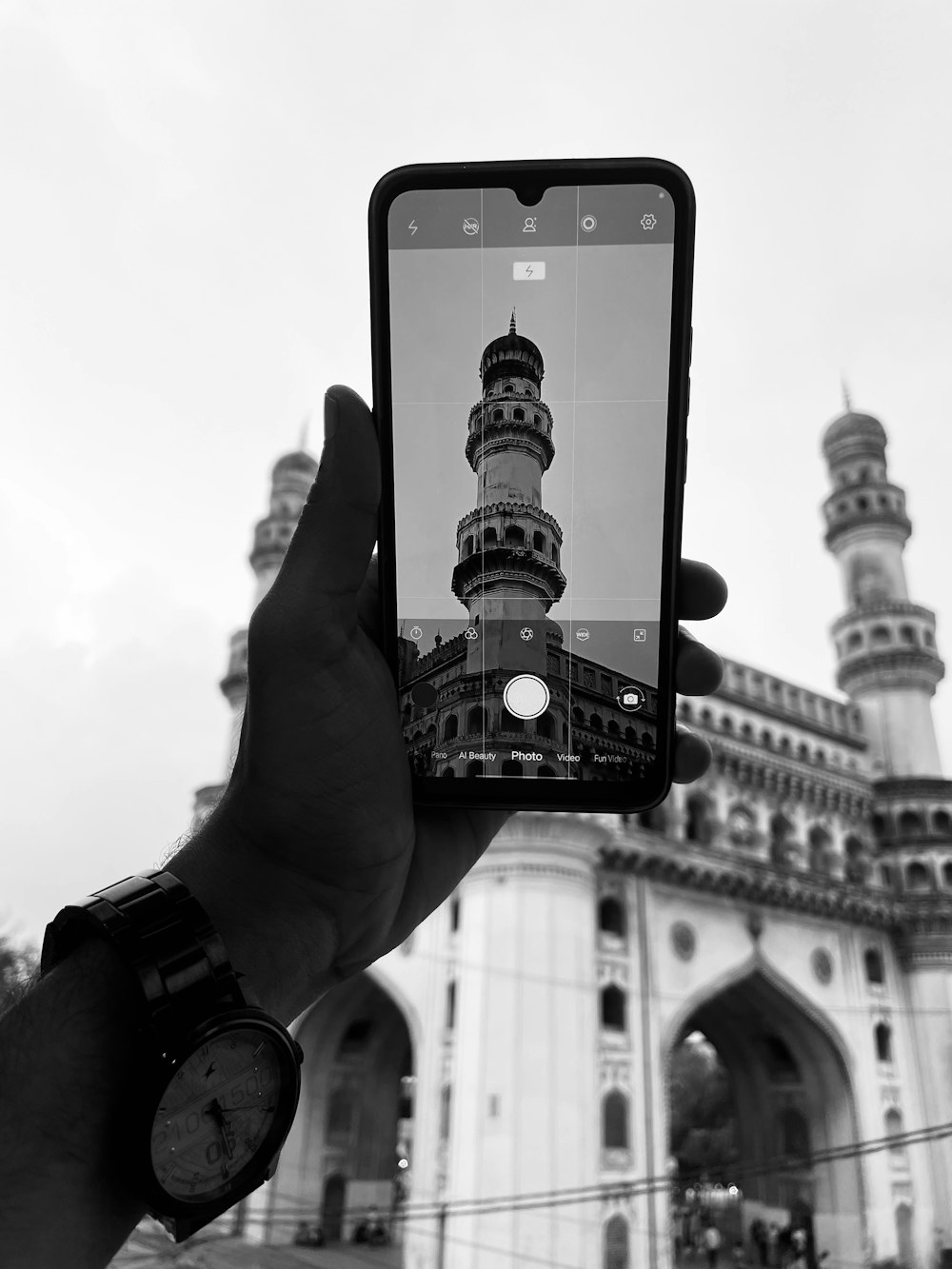 a person taking a picture of a building with a cell phone