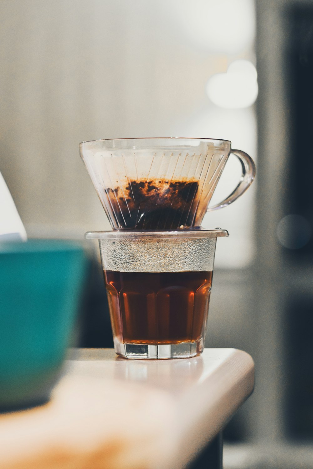 a cup filled with liquid sitting on top of a table