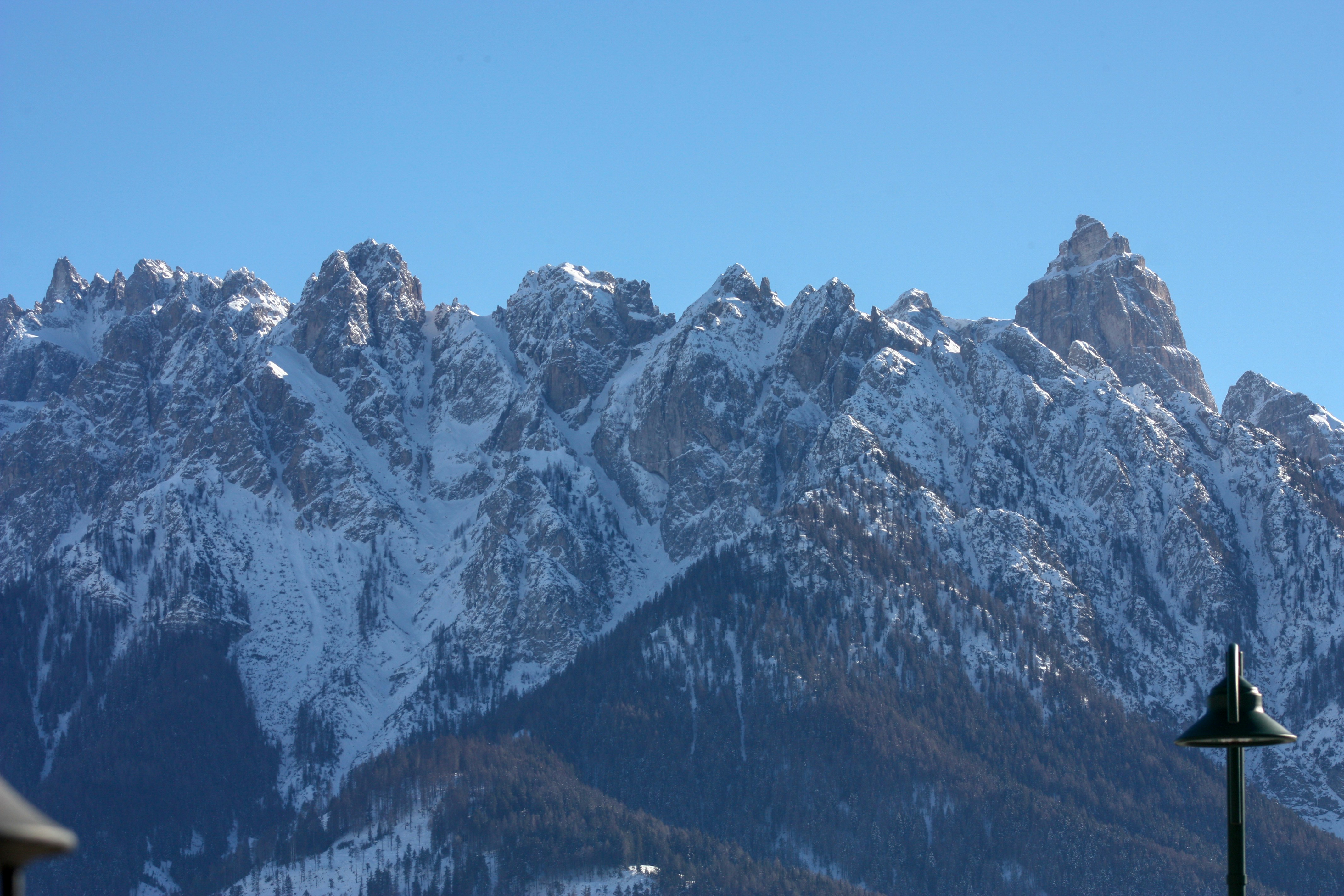 a view of a snowy mountain range from a balcony