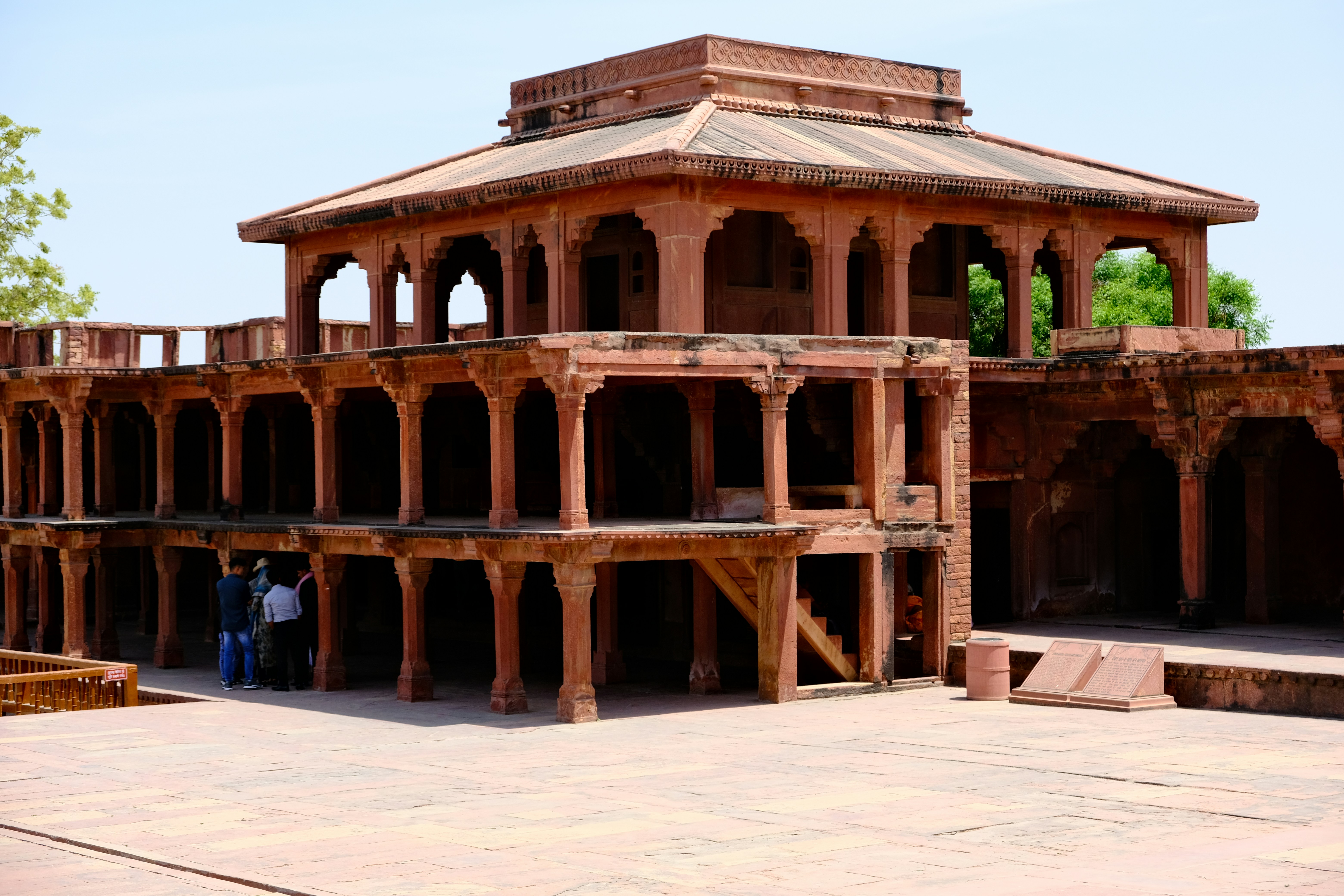Traditional Rajasthani haveli with pink sandstone walls, carved archways, and courtyard fountain
