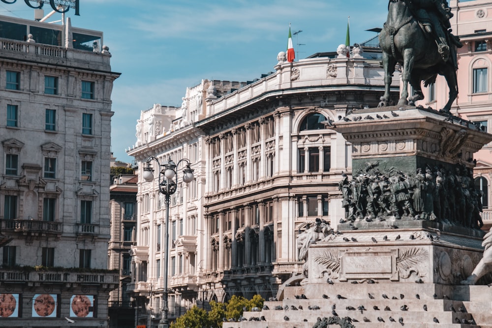 a statue of a man on a horse in front of a building