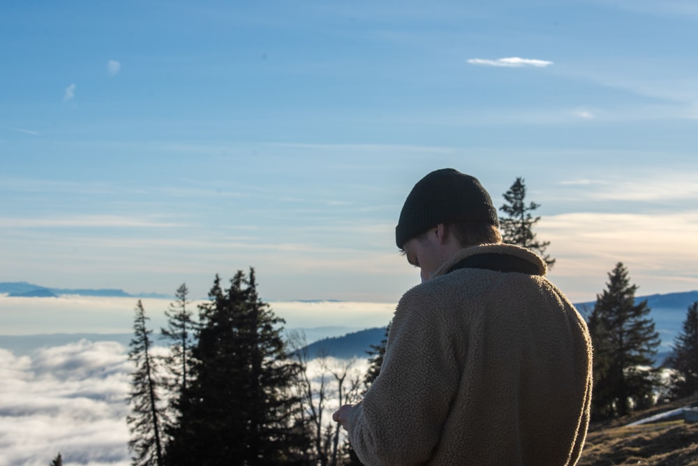 a man standing on top of a snow covered slope