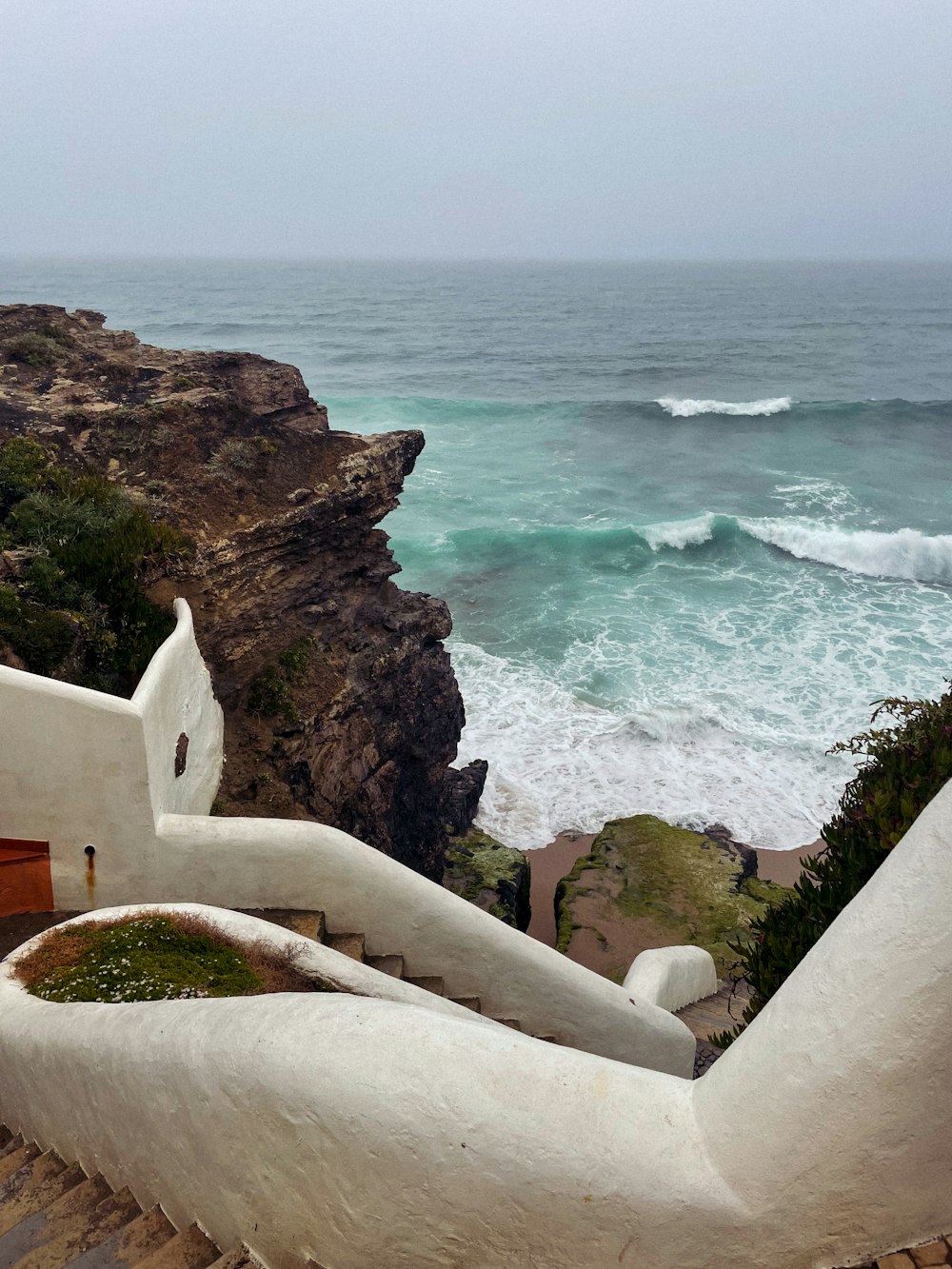 a view of the ocean from the top of a staircase