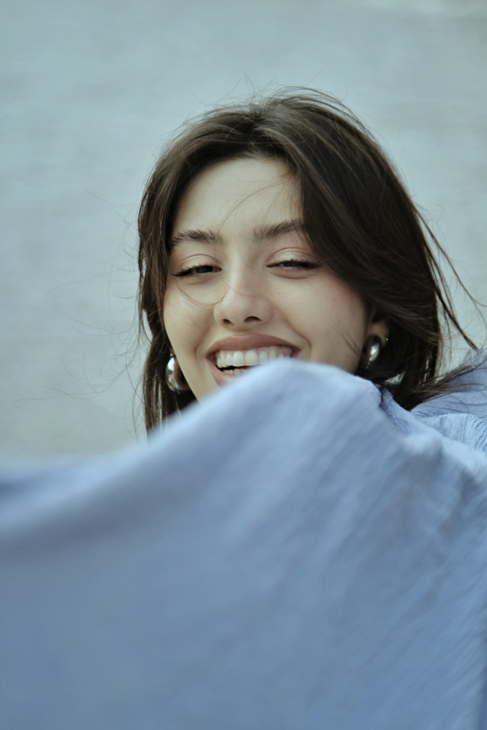 a woman with her eyes closed smiling