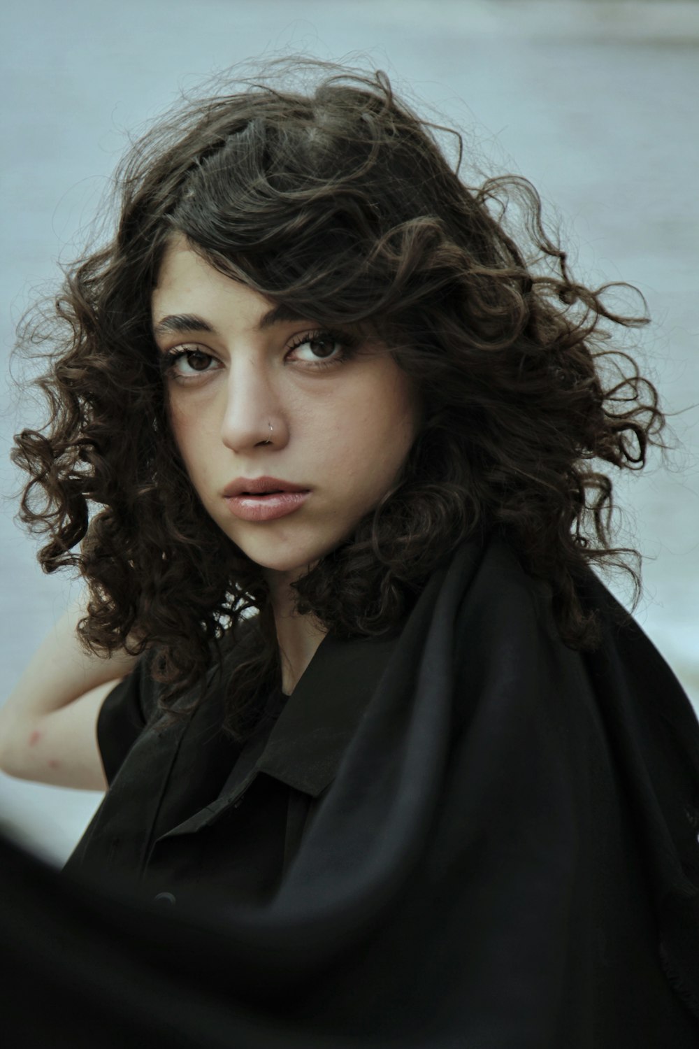 a woman with curly hair and a black shirt