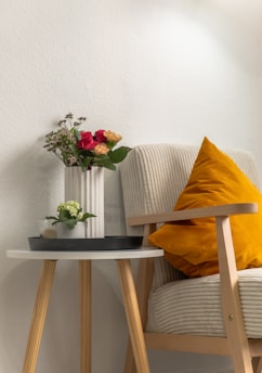 a small table with a vase of flowers on it