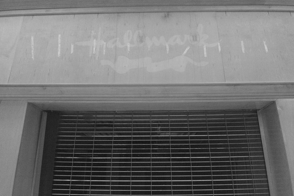 a black and white photo of a building with graffiti on it