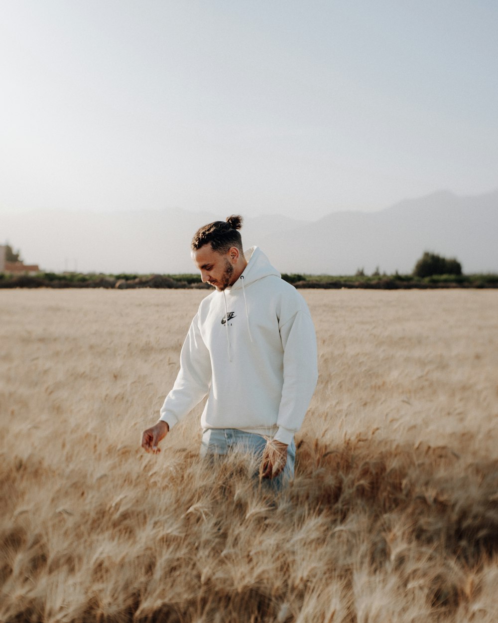 a man standing in a field of wheat