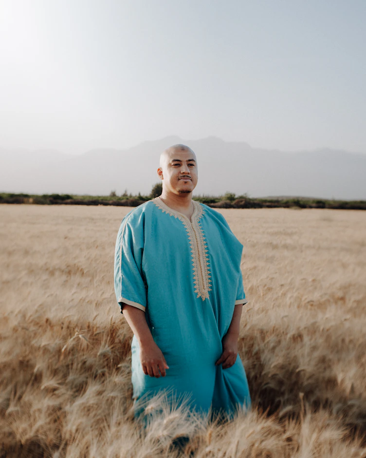 a man standing in a field of tall grass