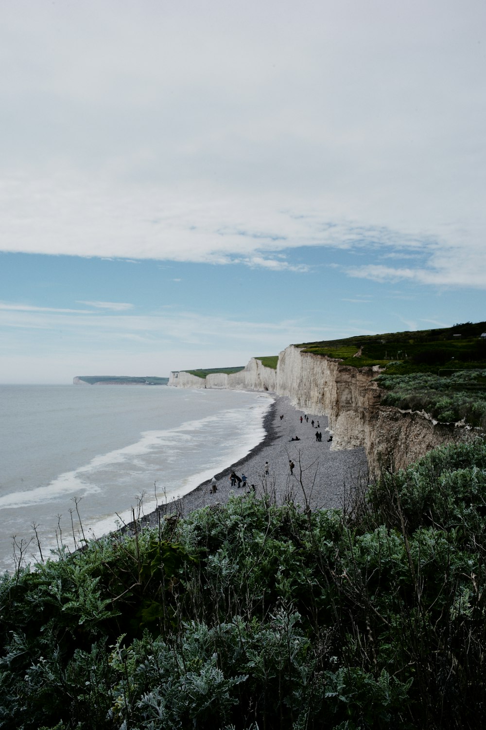 a view of a beach with a cliff in the background