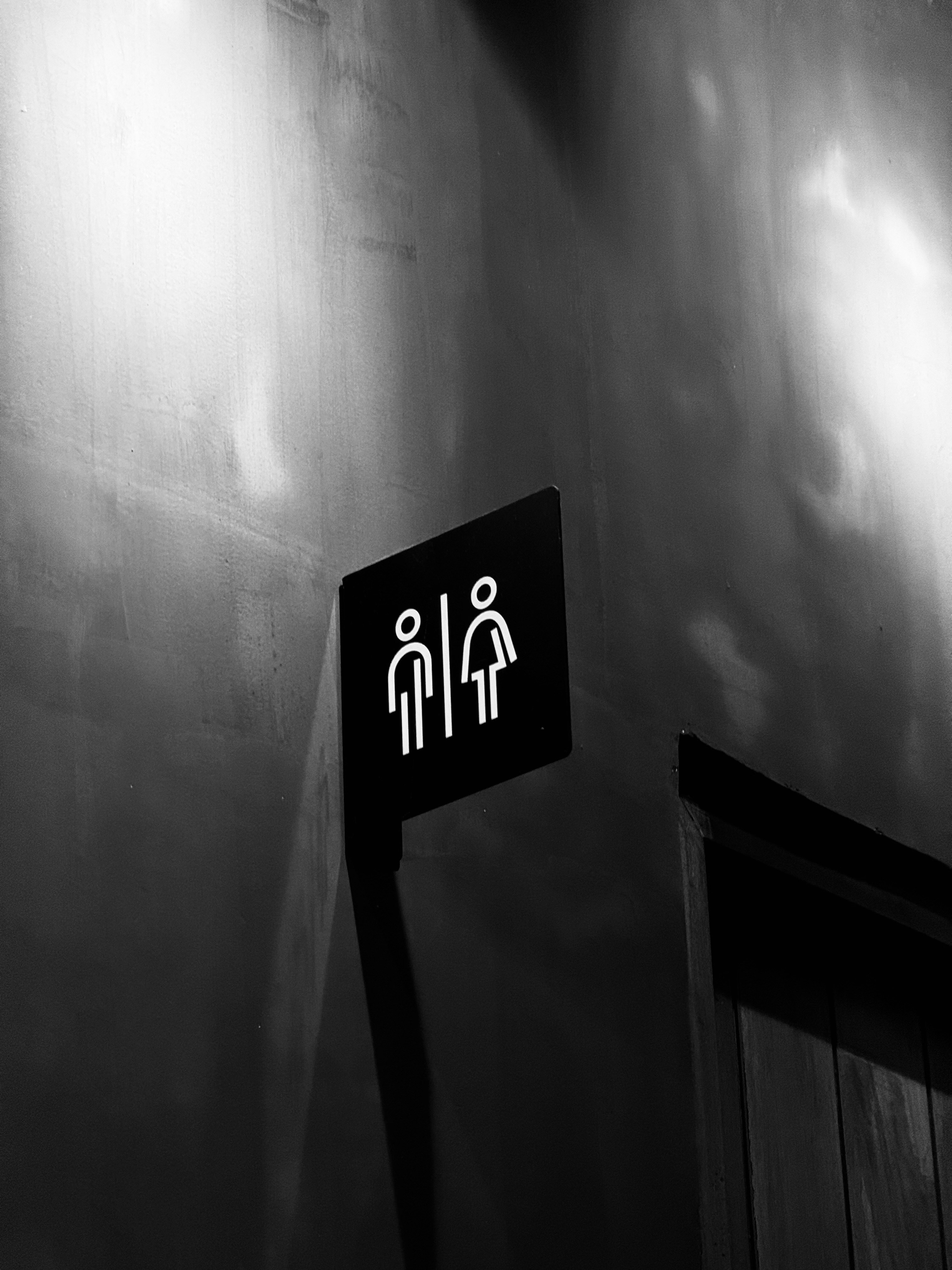 a black and white photo of a restroom sign