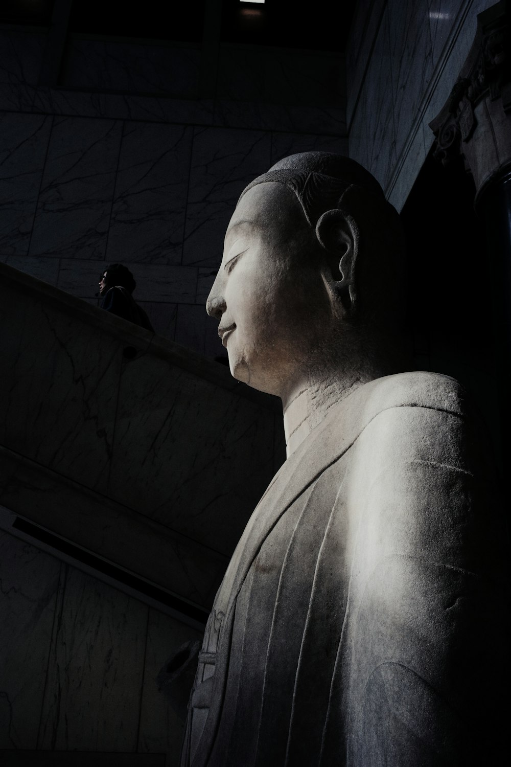 a large statue of a man in a dark room