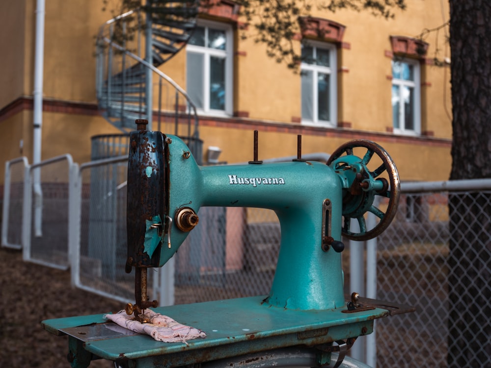 a green sewing machine sitting on top of a table