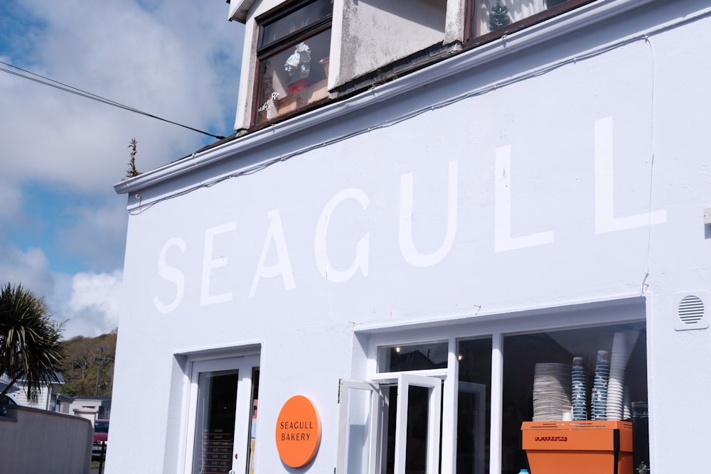 a white building with a sign that says seagull