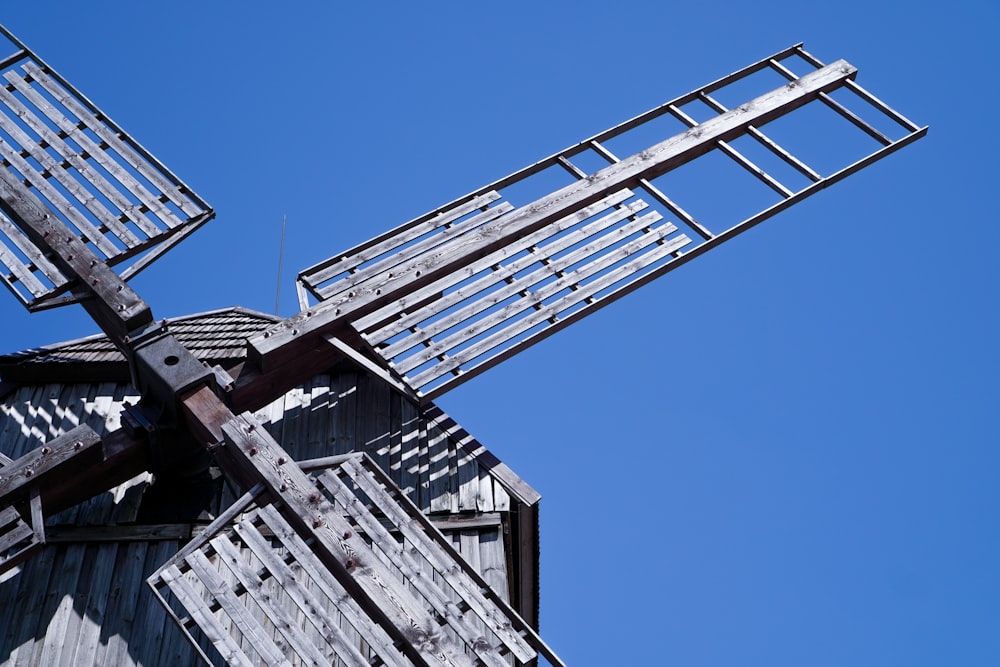 a metal windmill with a blue sky in the background