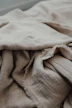 an unmade bed with a blanket on top of it