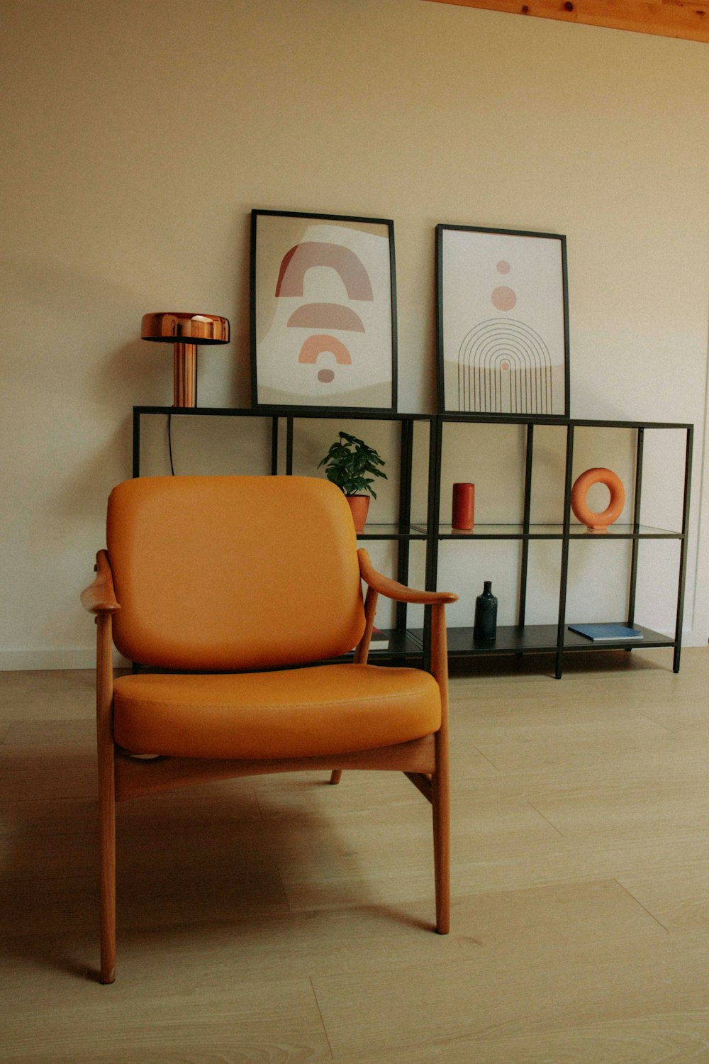 a living room with a chair and a shelf