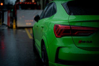 a green car parked on the side of the road