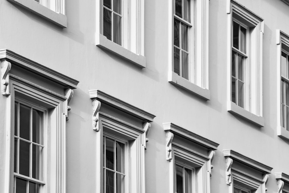 a black and white photo of windows on a building