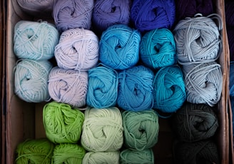 several balls of yarn are in a box
