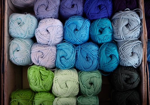 several balls of yarn are in a box