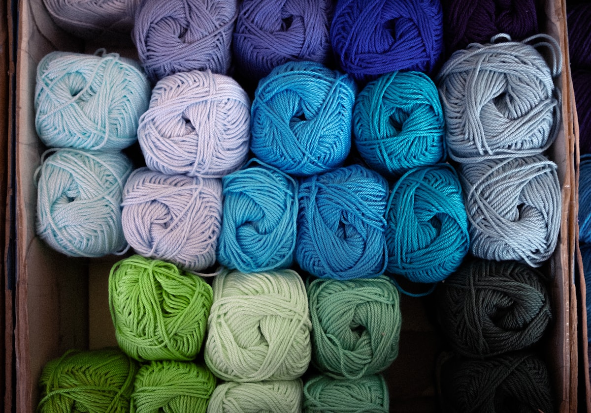 Several balls of yarn stored neatly together in a box